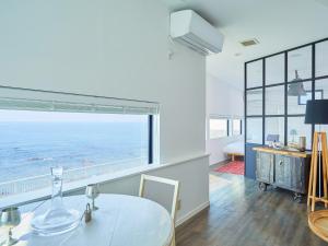 a dining room with a table and a view of the ocean at &SUN Terrace house - Vacation STAY 67119v in Yokosuka