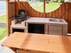 a outdoor kitchen with a table and a sink at &SUN Hung five - Vacation STAY 67613v in Minamiboso