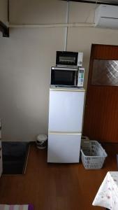 a microwave sitting on top of a white refrigerator at Yagisawa Home - Vacation STAY 67831v in Nikko