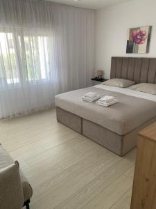 a bedroom with a bed with two towels on it at Room with Balcony and Sea View in Zadar +11 photos