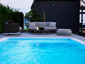 a swimming pool with a couch and a table next to a pool at CAP MARTIN Funny house - Vacation STAY 68833v in Minamiboso