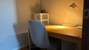 a desk with a blue chair at a desk with a lamp at Toyoura Ocean House - Vacation STAY 15447 in Toyoura