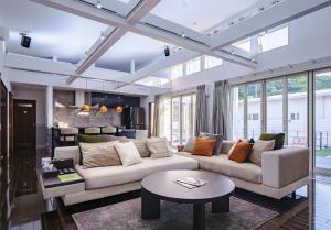 a living room with a couch and a table at MIYAZAKI BASE in aoshima - Vacation STAY 82721v in Miyazaki