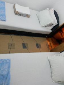 a bed with white sheets and pillows in a room at Apartment Tijana in Sutomore