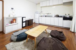a large kitchen with a wooden table and a wooden floor at BBQ & Residence Tokoname - Vacation STAY 86709v in Tokoname