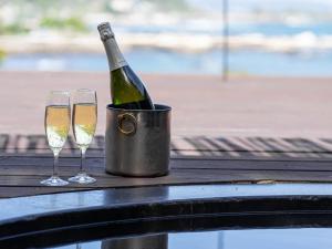 a bottle of champagne in a bucket next to two glasses at Lost Cabin - Vacation STAY 89724v in Kamogawa