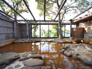 a house with a pond and rocks in it at Shimanto Yamamizuki - Vacation STAY 20668v in Shimanto