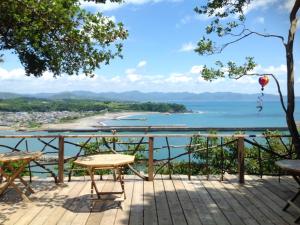 a deck with a table and chairs and a view of the ocean at Shimanto Yamamizuki - Vacation STAY 20668v in Shimanto