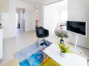a living room with a television and a black chair at Vent du Vent 5F - Vacation STAY 90722v in Urasoe
