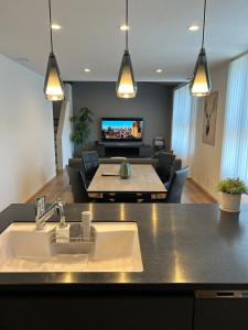 a kitchen and living room with a sink and a table at Shinchiku design house - Vacation STAY 15468 in Ranzan