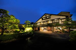 a building with a river in front of it at Kaike Fuga in Yonago