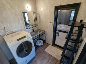 a washing machine in a bathroom with a sink and a tub at KOZA River House Yukawatei - Vacation STAY 95522v in Koza