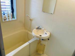 a white bathroom with a sink and a bath tub at Real Corp 202 - Vacation STAY 78099v in Chiba +9 photos