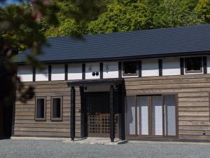 a large wooden building with a large door at solii - Vacation STAY 98415v in Ishikari