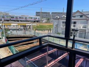 a view from a balcony with a train on the tracks at Real Corp 202 - Vacation STAY 78099v in Chiba