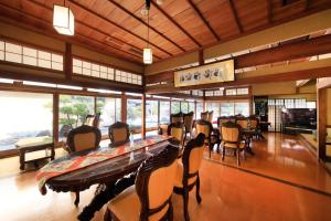 a dining room with a long table and chairs at Kaike Fuga in Yonago