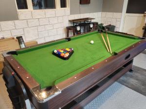 a pool table with a ball and cues on it at Seaside Garage Shima - Vacation STAY 85765v in Shima