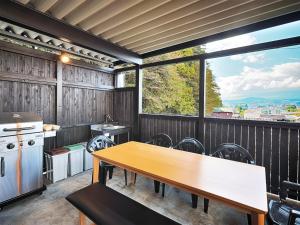 a kitchen with a table and a large window at Asama no Iori - Vacation STAY 01001v in Fujiyoshida