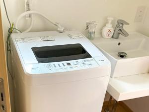 a white washing machine sitting next to a sink at Asama no Iori - Vacation STAY 01001v in Fujiyoshida +36 photos