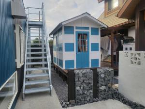 a small house with a ladder next to a building at Seaside Garage Shima - Vacation STAY 85775v in Shima
