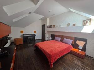 a bedroom with a bed with a red blanket at Casa Italiana with Exclusive Pool in Odesa