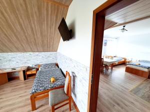 a living room with a table and a couch at Nocleg Hotel Nad Stawami in Brzostek