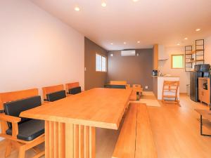 a conference room with a large wooden table and chairs at Asama no Iori - Vacation STAY 00978v in Fujiyoshida