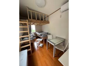 a room with a bunk bed and a desk and a table at Oasis Minamiboso - Vacation STAY 04676v in Minamiboso