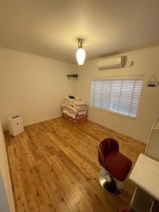an empty room with a chair and a bed at VAMOS the Beach Front - Vacation STAY 20655v in Tokunoshima