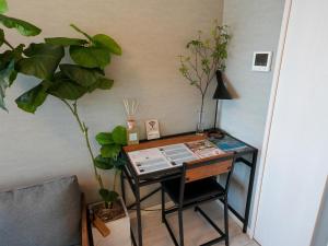 a desk in a room with a plant and a lamp at REVISION Kairouyama-tei - Vacation STAY 15802 in Hiroshima