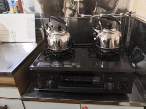 two tea pots sitting on top of a stove at Bouldering & SPA -Ariki Resort Shuzenji ANNEX- - Vacation STAY 07698v in Izu +17 photos