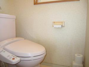 a bathroom with a toilet and a toilet paper dispenser at Kabato County - Camp - Vacation STAY 42252v in Shintotsukawa