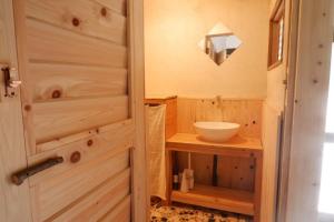 a bathroom with a wooden door and a sink at Casa de Mano - Vacation STAY 21638v in Mihara +18 photos