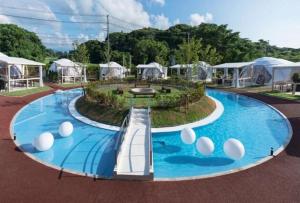 a large blue swimming pool with white balls in it at 99glam - Vacation STAY 42273v in Hirasawa