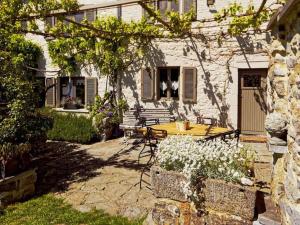 a house with a table and chairs in the yard at Charming cottage in a farm with views in Gimnée +34 photos