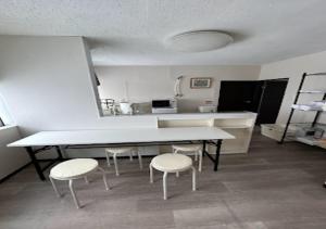 a kitchen with a table and two chairs and a counter at Ota Apartment - Vacation STAY 17531 in Otaru