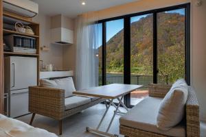 a kitchen and living room with a table and chairs at R;MOGAMI - Vacation STAY 25467v in Kiyokawa