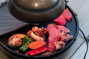 a close up of a grill with meat and vegetables at R;MOGAMI - Vacation STAY 25467v in Kiyokawa +13 photos