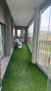 a balcony with green grass in a house at Luminoso 3 Rooms Vistas Pirineo in Sabiñánigo