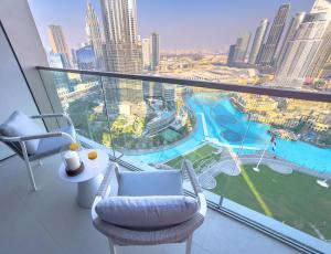 a room with a view of a city from a building at GRANDE RESIDENCES with a direct Burj Khalifa view and Private Fountain Show at 62nd floor with DXB AIRPORT VIP Shuttle option for 8 guests in Dubai