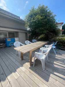 a wooden picnic table and chairs on a deck at art village - Vacation STAY 20642v in Awa +5 photos