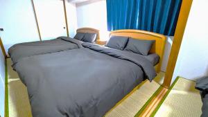 a bedroom with a large bed with a wooden headboard at Space Minami 4jo - Vacation STAY 17247 in Sapporo