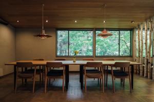 a dining room with a large wooden table and chairs at Mizuho Highland - Camp - Vacation STAY 42325v in Utsunobara