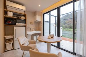 a kitchen and living room with a table and chairs at R;MOGAMI - Vacation STAY 25489v in Kiyokawa +10 photos