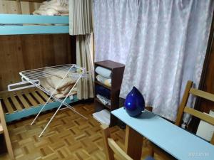 a room with a bunk bed and a desk and a table at ImagineWestOcean - Vacation STAY 15910 in Suo Oshima