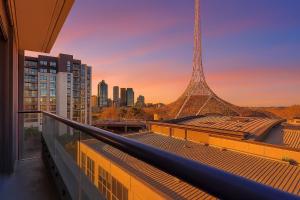 a view of the eiffel tower from the balcony of a building at Spacious Apartment in Heart of Southbank in Melbourne