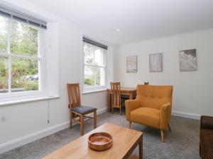 a living room with a table and chairs at Flat 2 Battledown Grange in Cheltenham