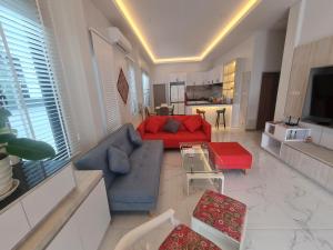a living room with a red couch and a table at Home sweet home by Pinky in Ban Sai Thai