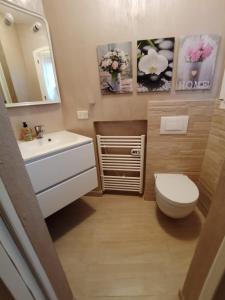 a bathroom with a sink and a toilet and a mirror at Villetta Isor con piscina in Costa Paradiso +25 photos
