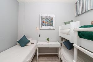 a small room with two bunk beds and a table at Seagull 507 in Margate
